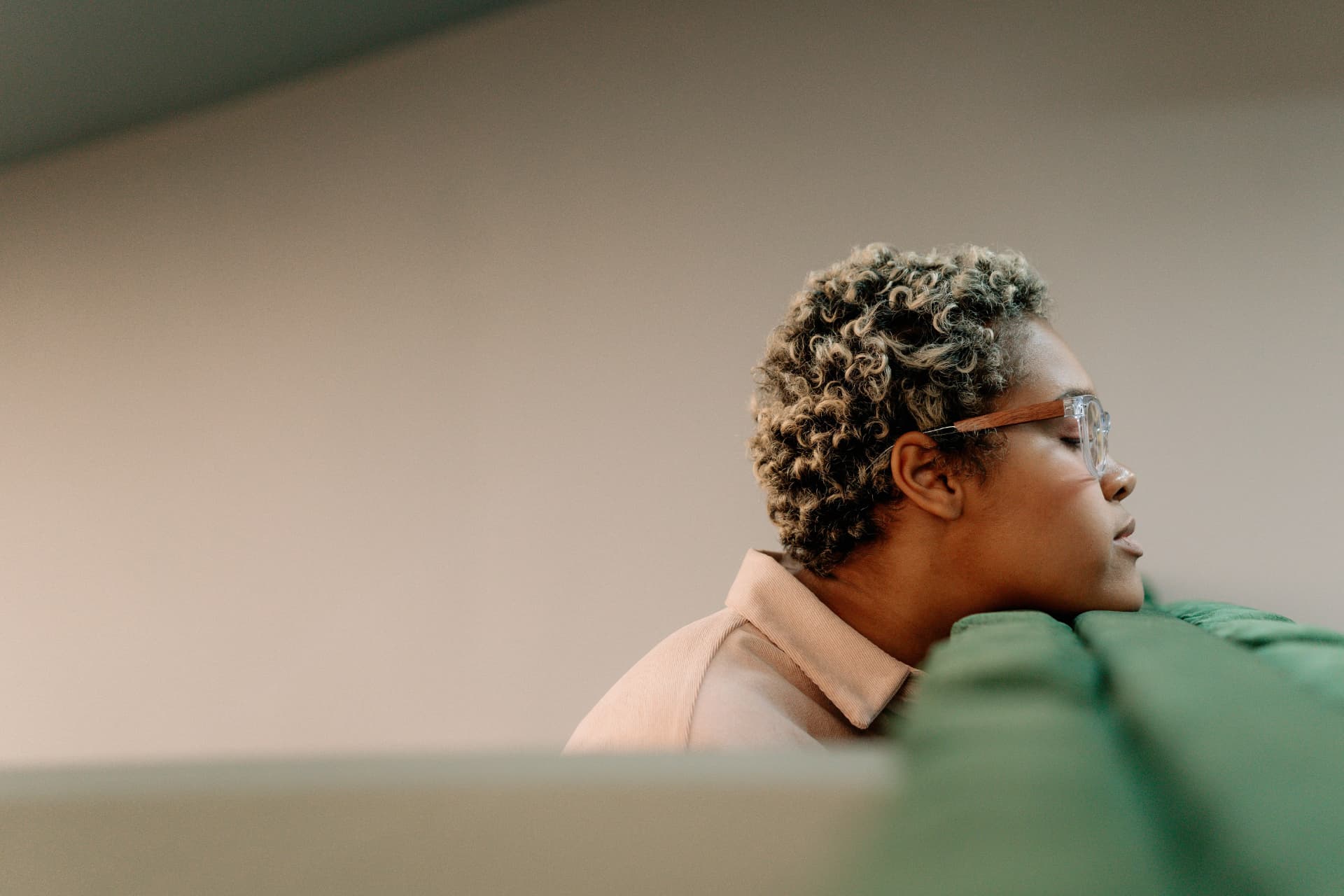 A person resting thoughtfully while considering how to seek healthcare