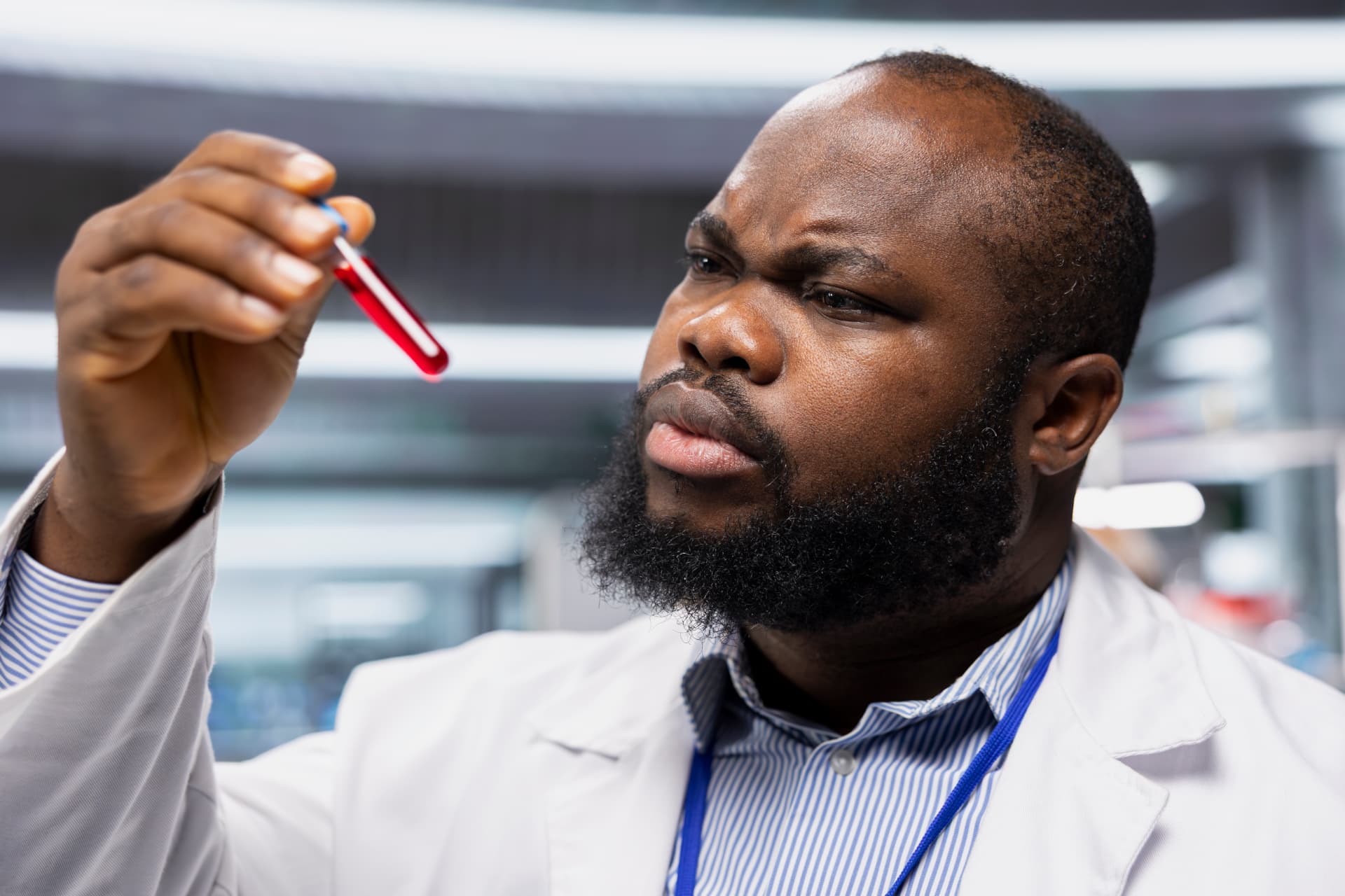A healthcare professional examining a blood sample in a clinical laboratory setting