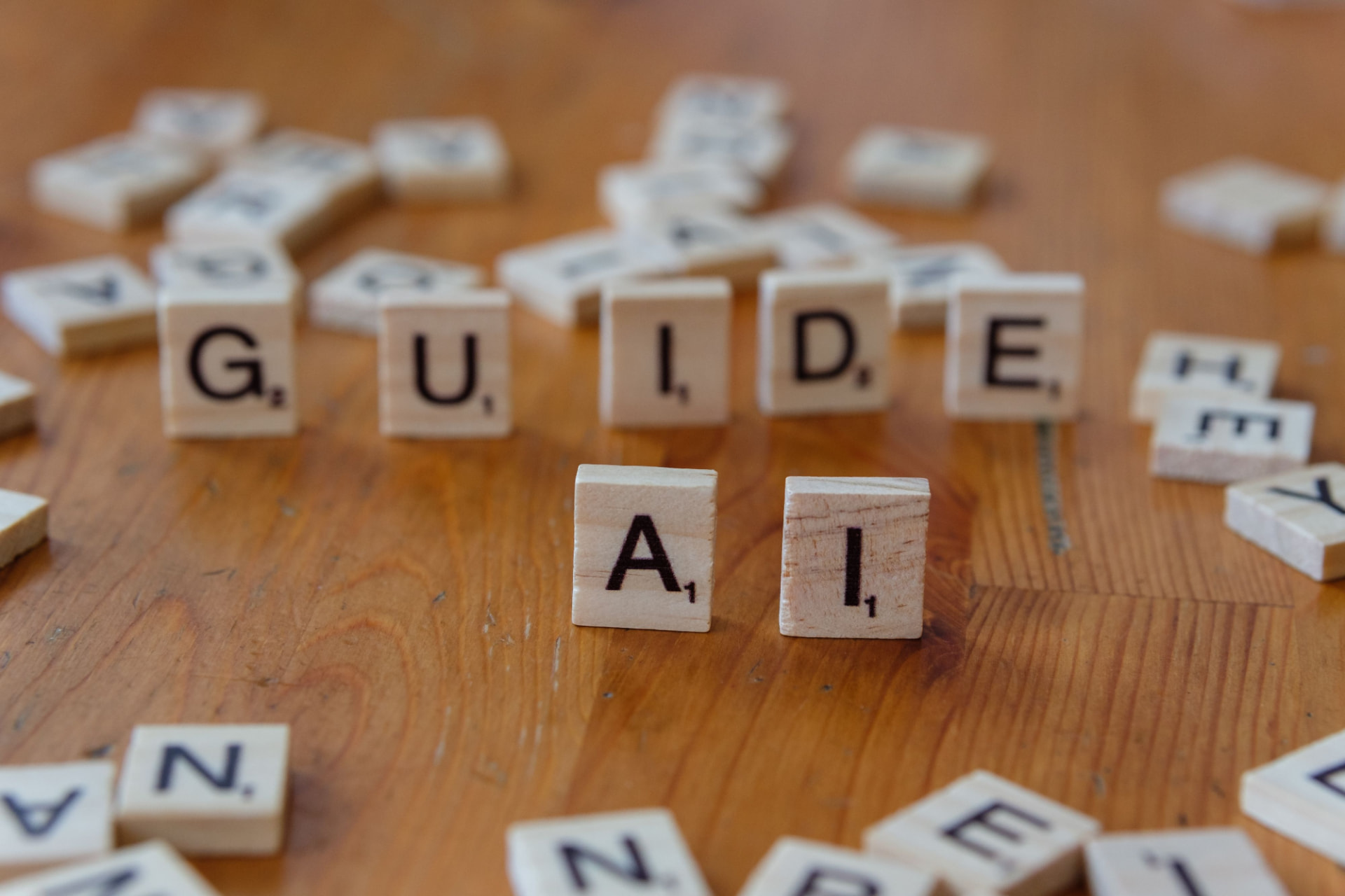 Scrabble tiles spelling GUIDE and AI, representing AI as a guide in healthcare